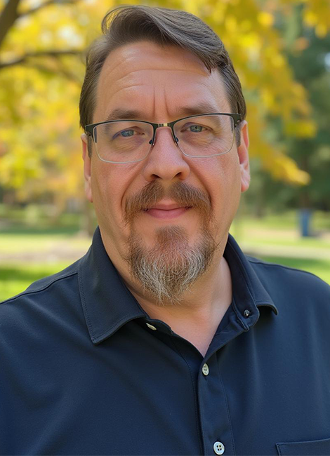 Brian Hogsett – Learning & Development Leader headshot in park setting, professional Learning & Development Leader